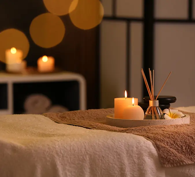 Peaceful spa ambiance with lit candles and essential oils at a luxury Himalayan wellness retreat.