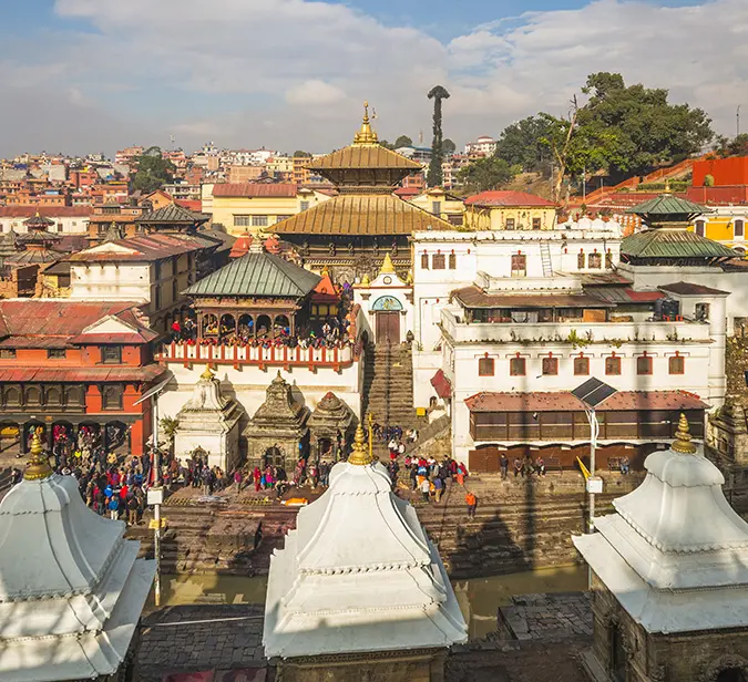 Historic Pashupatinath Temple in Nepal with vibrant crowds and architecture.