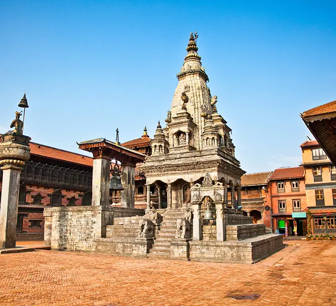 UNESCO-listed historic stone temple at Bhaktapur Durbar Square surrounded by red-brick courtyard.