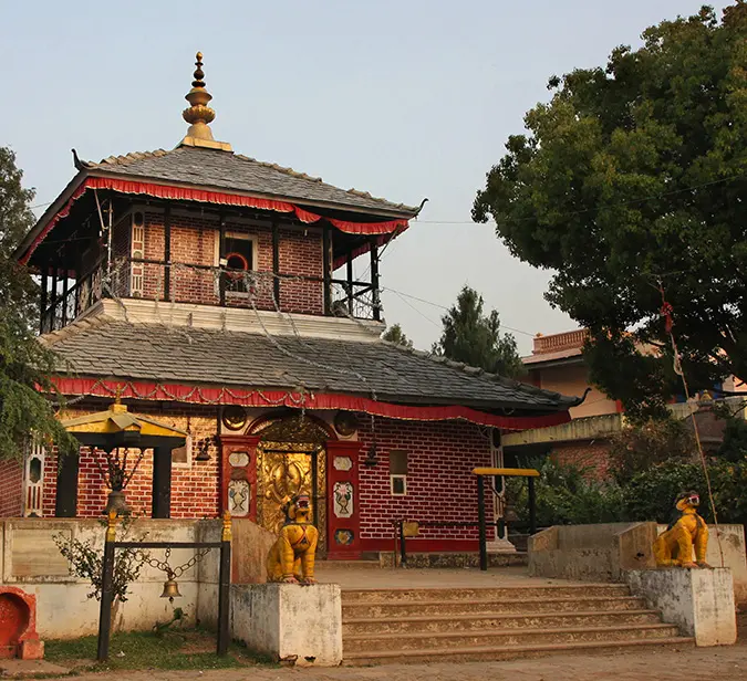 Historic temple entrance with golden idol in hill town of Tansen, Nepal.