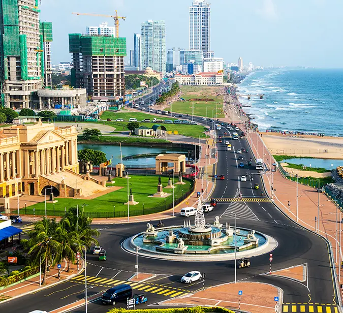Bustling roundabout and coastal skyline in vibrant Colombo, Sri Lanka.