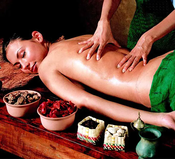 Ayurvedic back massage with natural herbs and oils during a wellness retreat in Weligama, Sri Lanka.