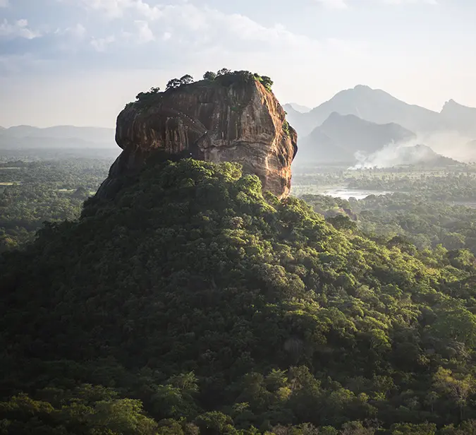 Sigiriya Rock Fortress with panoramic views of the green plains below in Sri Lanka.
