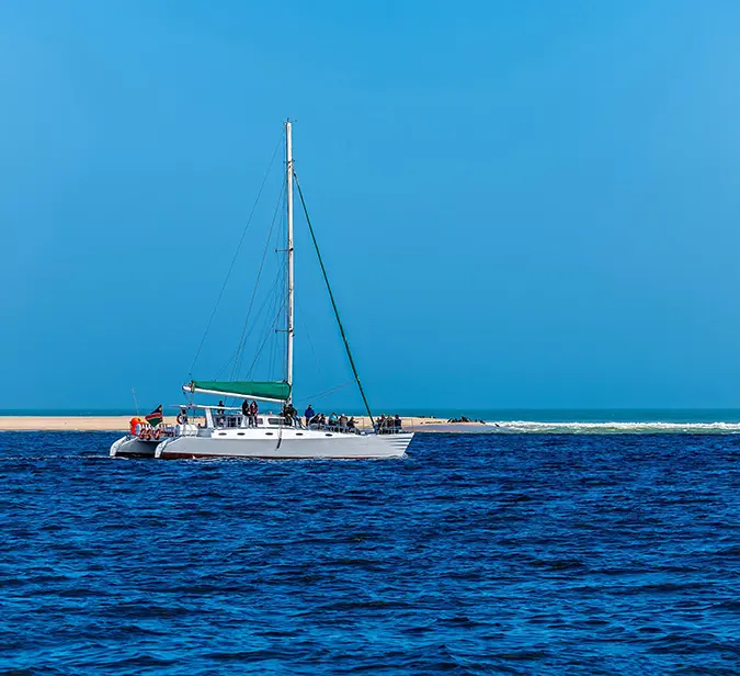 Catamaran cruise off Pelican Point, Walvis Bay, with passengers enjoying ocean views and wildlife.