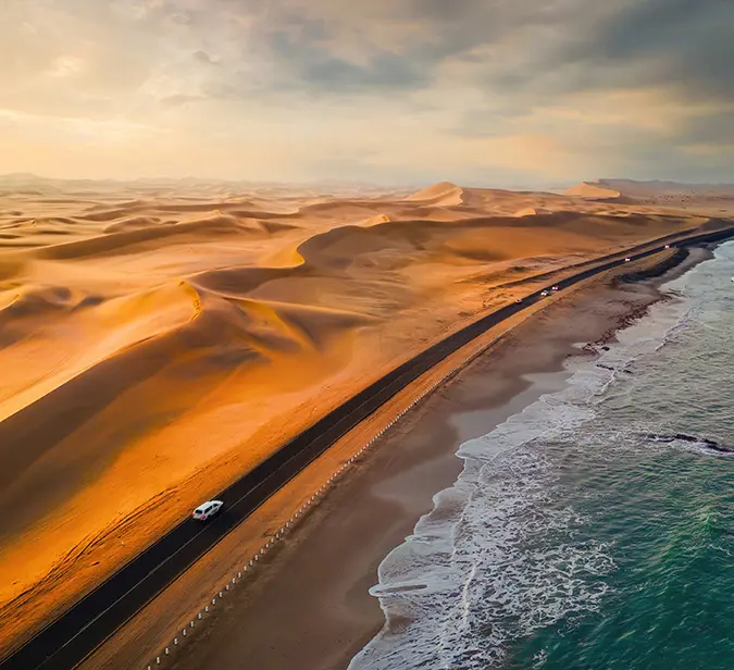 Scenic drive along Namibia’s Skeleton Coast, where desert dunes meet the Atlantic Ocean.
