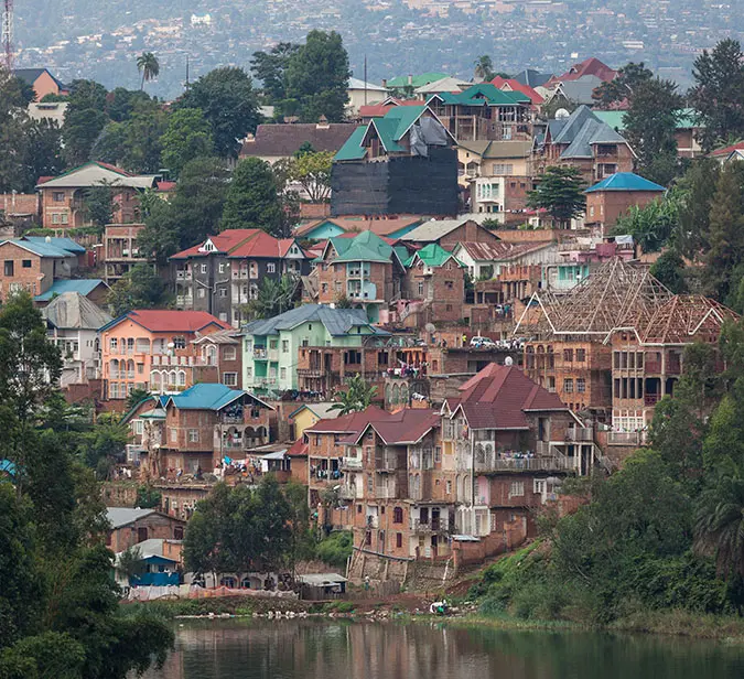 Dense urban hillside in Rwanda with colorful rooftops and serene natural surroundings.