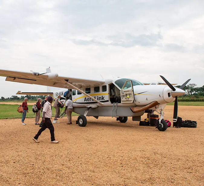 Travellers boarding a charter flight after exploring Uganda’s wildlife and landscapes.