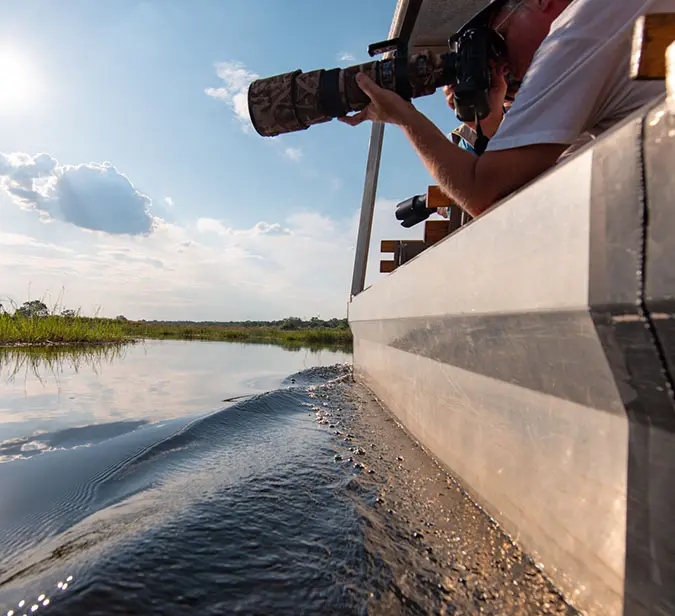 Man photographing coastal scenery during a cruise in Walvis Bay.