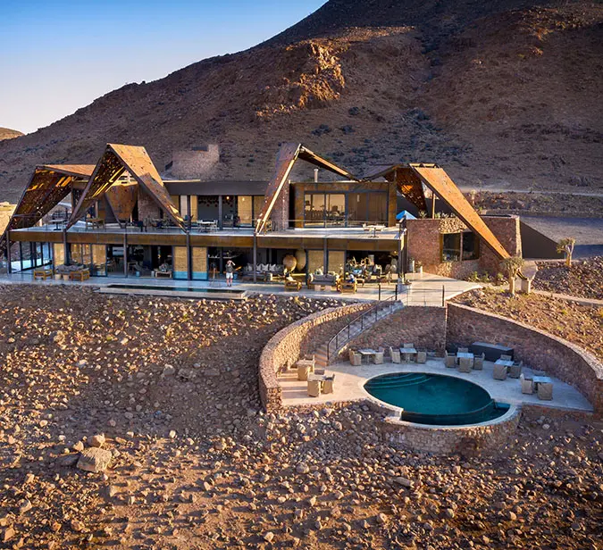 Scenic view of upscale lodge near rocky hills in Sossusvlei, Namibia.