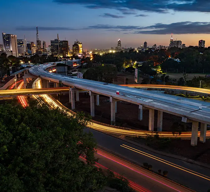View of Nairobi skyline and light trails from expressway, marking start of a safari adventure.