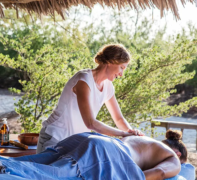 Open-air spa treatment with natural views on Mnemba Island.