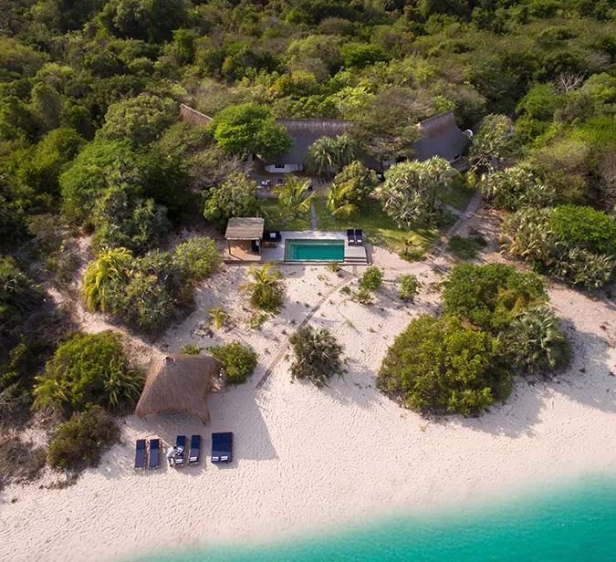 Aerial view of beachfront villa with private pool on Benguerra Island.