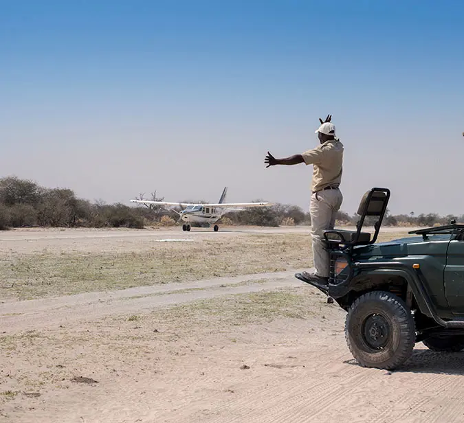 Safari guide directing a bush plane landing near Victoria Falls.