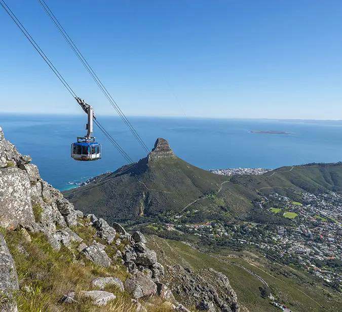 Scenic cable car ride over Cape Town with ocean and mountain views.
